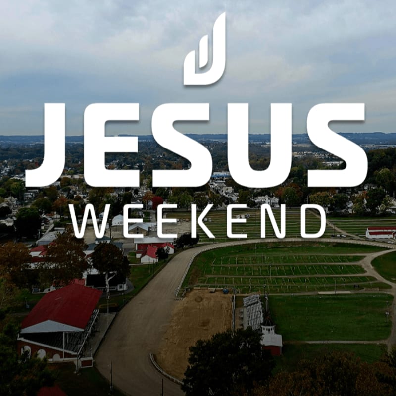White text reading "JESUS WEEKEND" with a stylized "J" logo overlays an aerial view of a town with a cemetery in the foreground and a cloudy sky in the background.