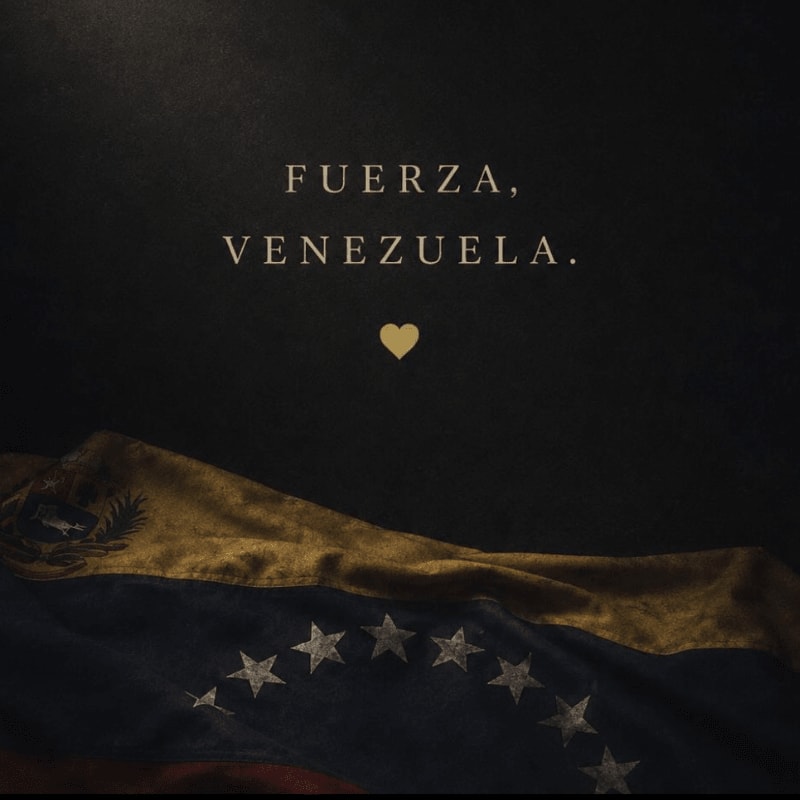A Venezuelan flag lies in the foreground against a dark background with the words "FUERZA, VENEZUELA." and a small golden heart above it.
