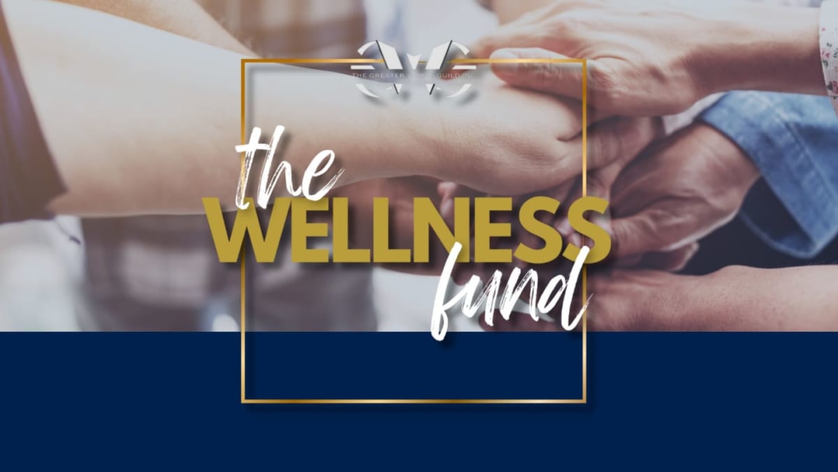 Hands are clasped together in the foreground, overlaid with a golden square containing the text "the WELLNESS fund" against a blurred background of people and a dark blue lower section.