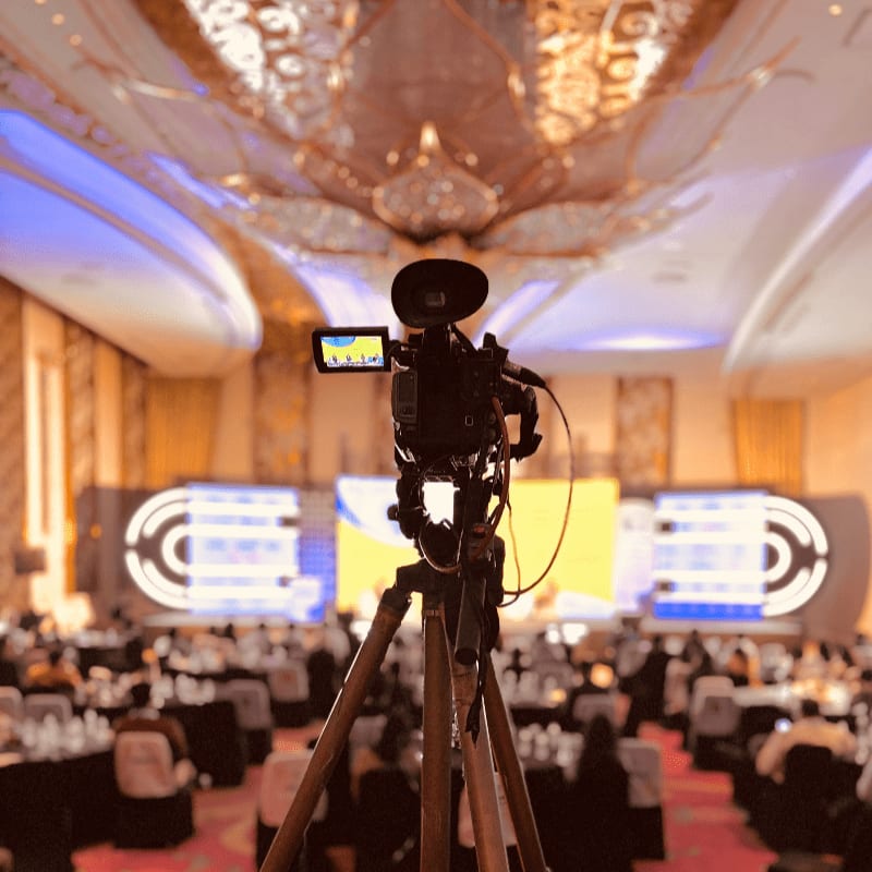 A camera set up on a tripod in a banquet hall