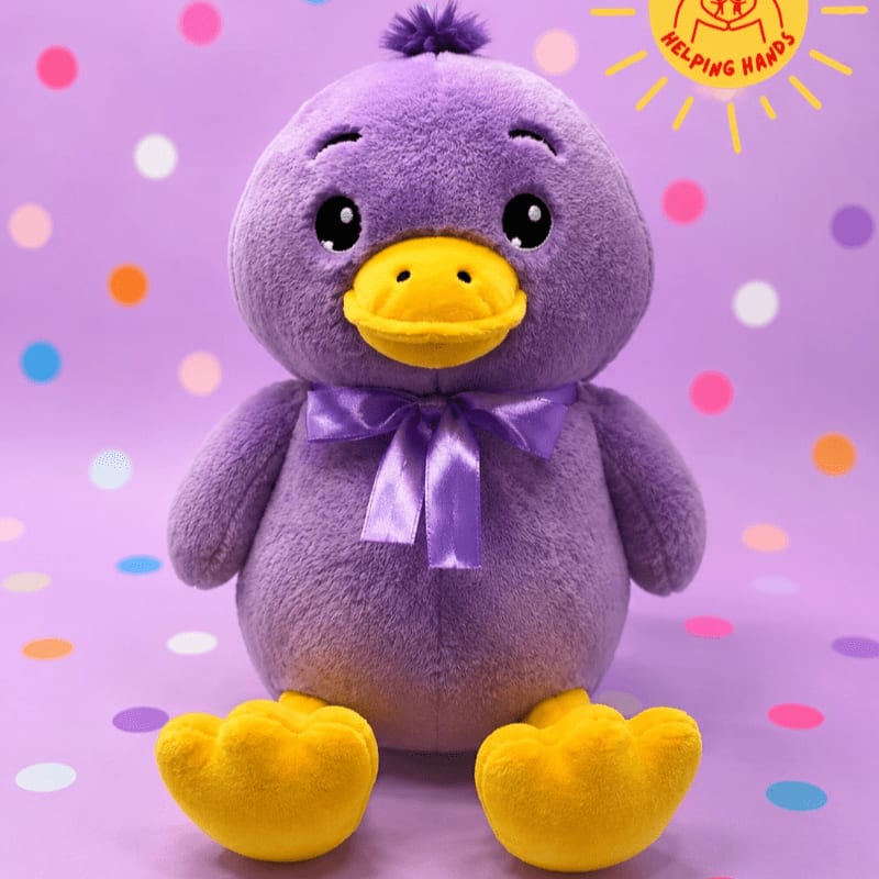 A fluffy purple duckling with yellow feet and a ribbon bow sits in the foreground against a lavender background with colorful polka dots and a "Helping Hands" logo.