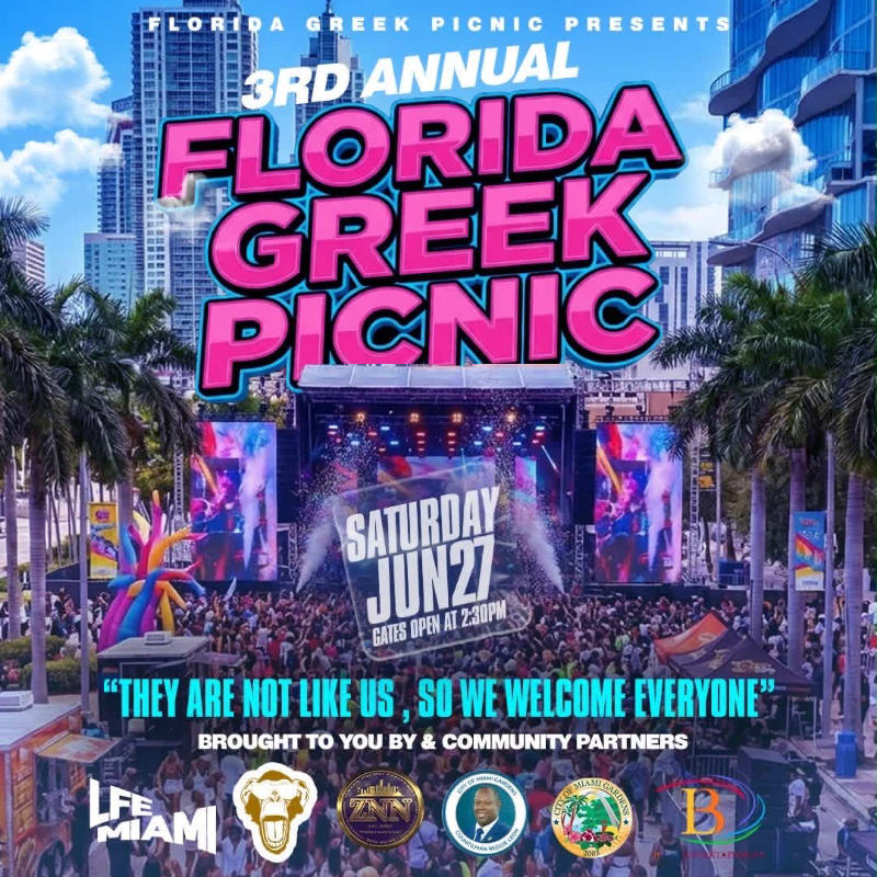 A large crowd gathers for the 3rd Annual Florida Greek Picnic in front of a stage with bright lights and city skyscrapers in the background.