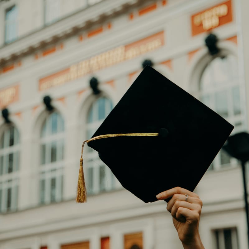 person holding black academic hat