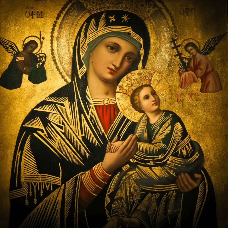 A gilded icon features the Virgin Mary holding the Christ child in the foreground, with two angels flanking them against a golden, textured background.