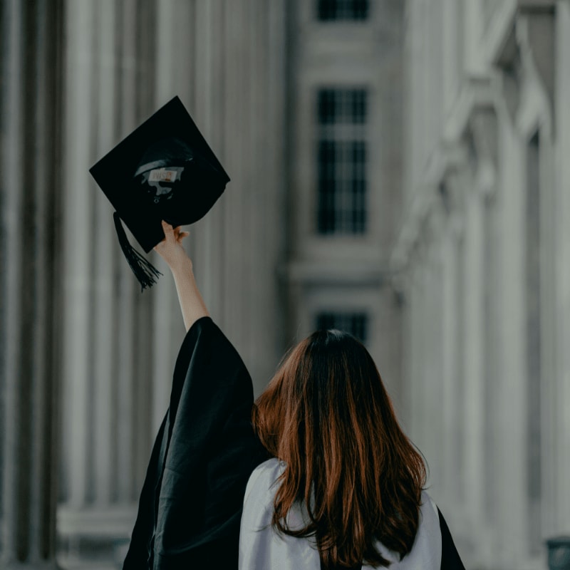 a woman in a graduation cap and gown