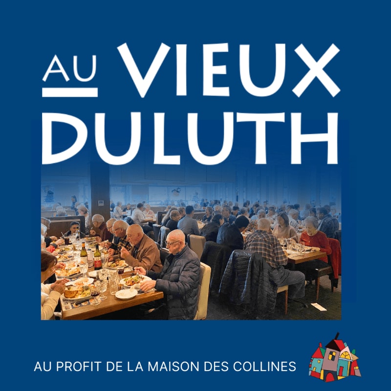 A group of people are seated at tables in a restaurant, with the text "AU VIEUX DULUTH" in large white letters against a blue background above them.