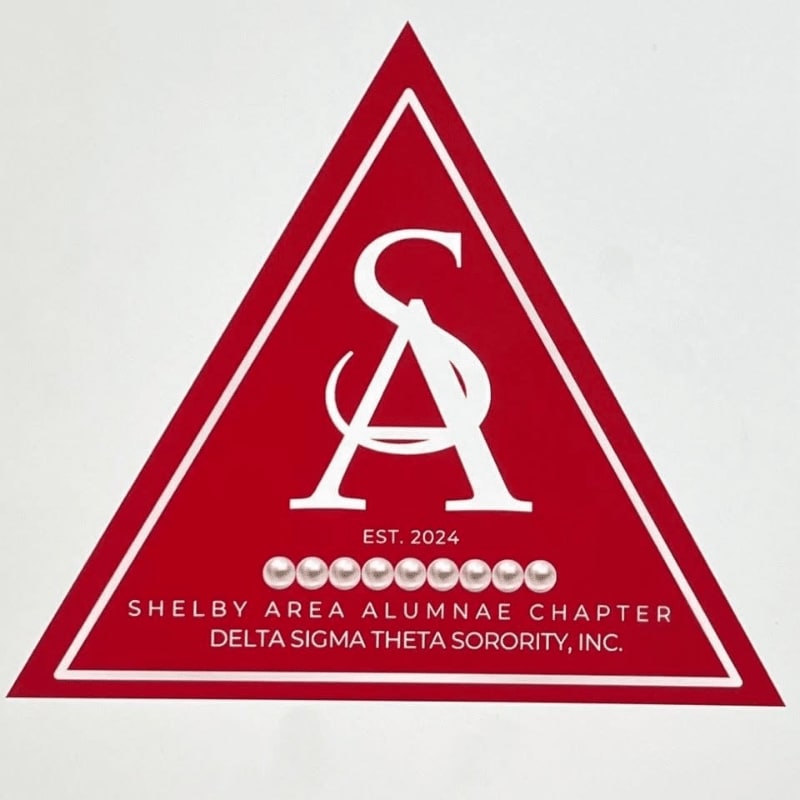 A red triangle with white lettering and pearls in the foreground is set against a white background.