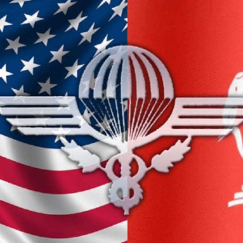 A split image features the American flag on the left and a red background with a silhouette on the right, overlaid with a white parachute and wings emblem.