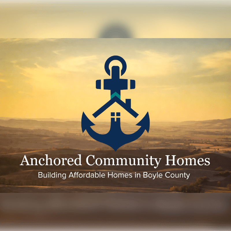 A dark, blurred foreground frames a logo of a blue anchor with a house silhouette inside, set against a backdrop of rolling hills bathed in the warm glow of a sunset.
