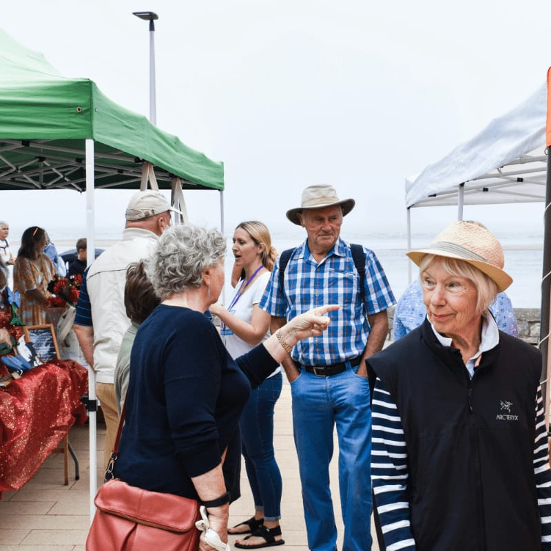 a group of people at an outdoor market