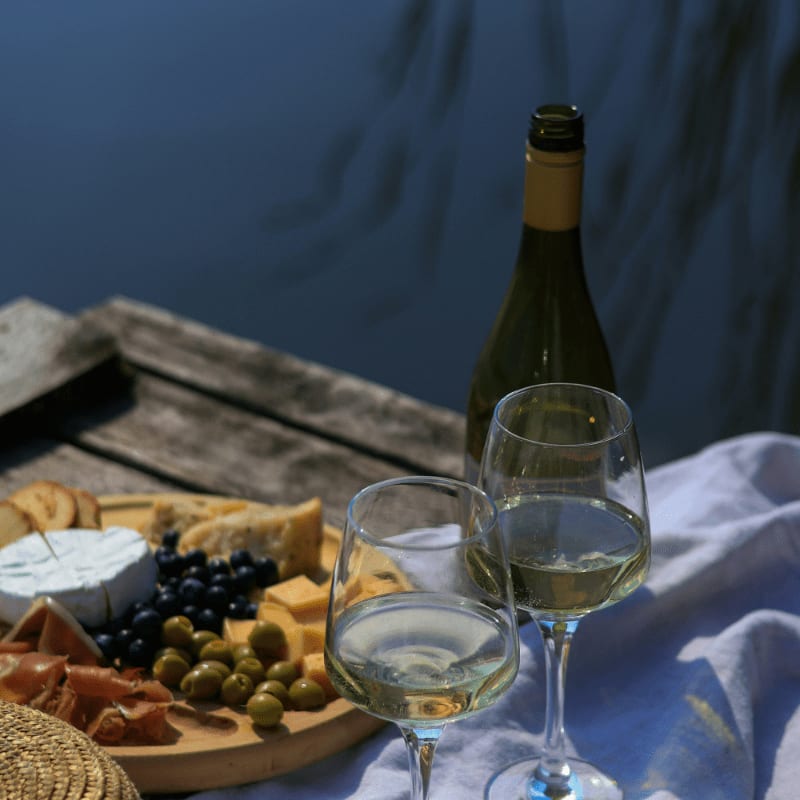 a bottle of wine and two glasses of wine on a table