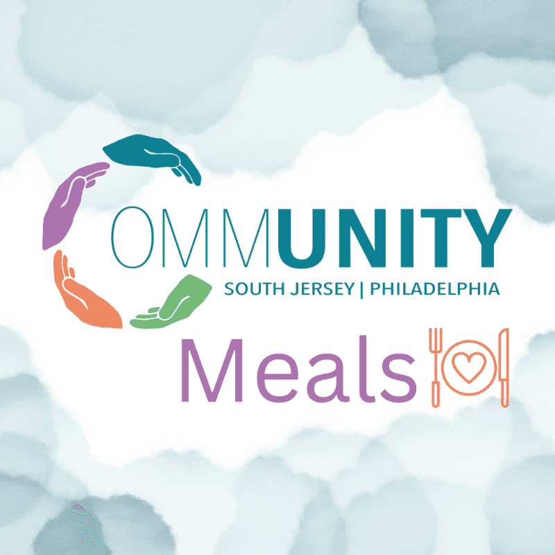 Colorful hands form a circle around the word "OMMUNITY" with "SOUTH JERSEY | PHILADELPHIA" below it, while "Meals" with a heart-shaped plate and cutlery is in the foreground, all set against a soft, cloudy blue and white background.