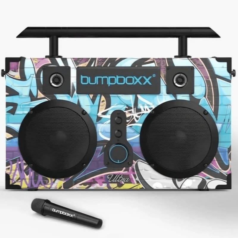 A graffiti-covered boombox with a microphone in the foreground sits against a white background.