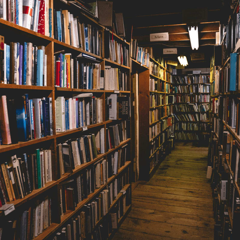 brown wooden book shelves with books