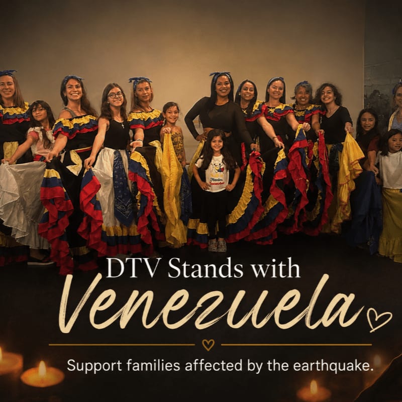 A group of women and girls in traditional Venezuelan attire stand in the foreground, holding Venezuelan flags, while the background features text supporting Venezuela and images of lit candles.