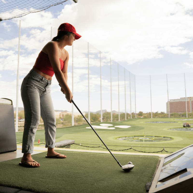 woman playing golf during daytime