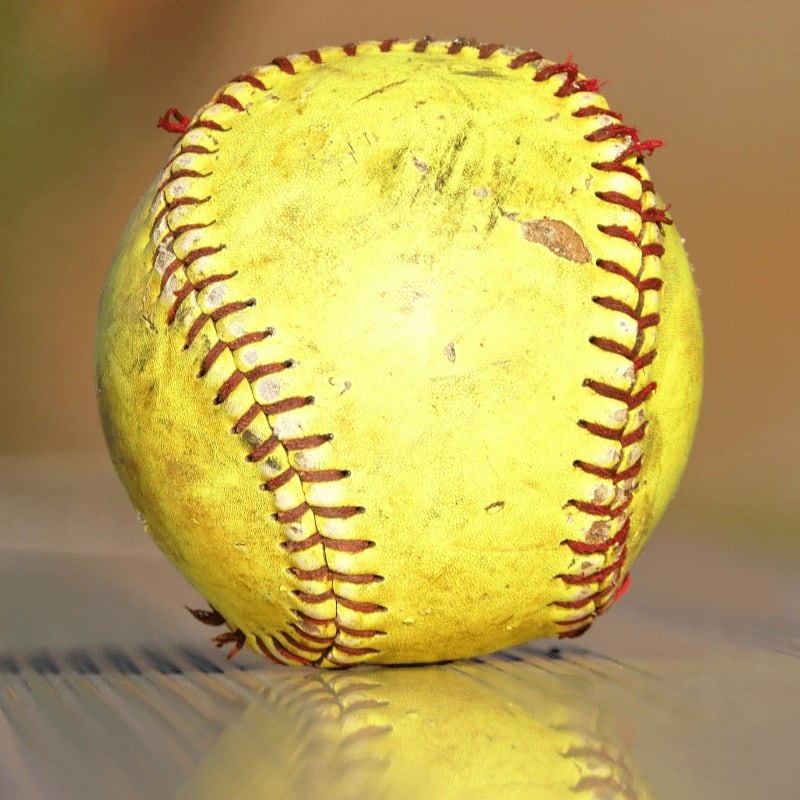 a yellow baseball sitting on top of a table