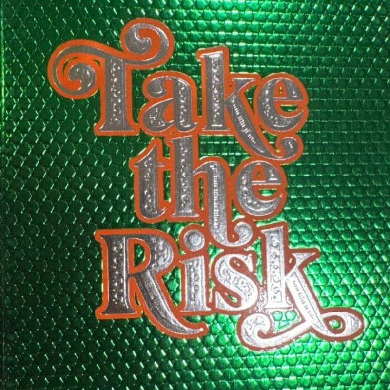 Silver and orange text reading "Take the Risk" is superimposed on a textured, metallic green background.