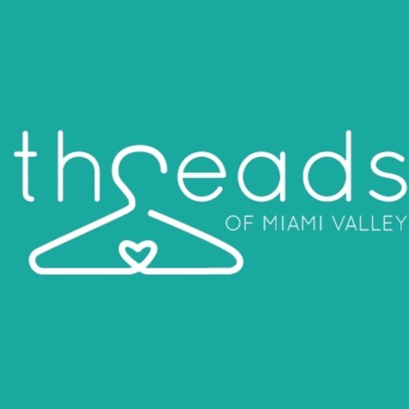 A white hanger with a heart inside forms the "h" in "threads," with "of Miami Valley" written to the right, all set against a teal background.