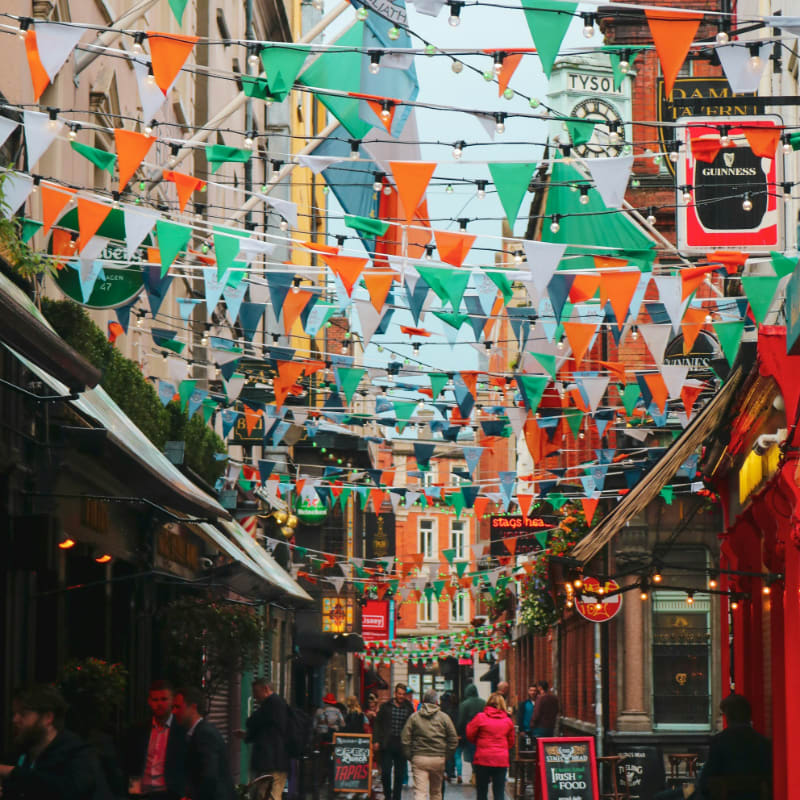 street with multicolored fiesta flags during daytime