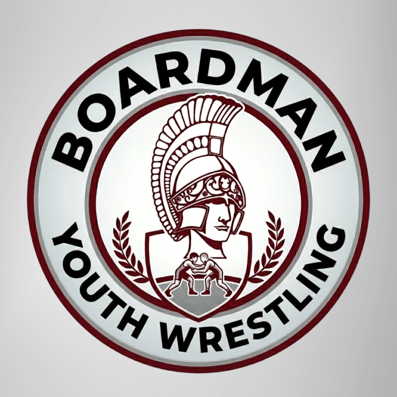 A circular logo with a Spartan helmet and wrestling figures in the foreground is set against a plain gray background.