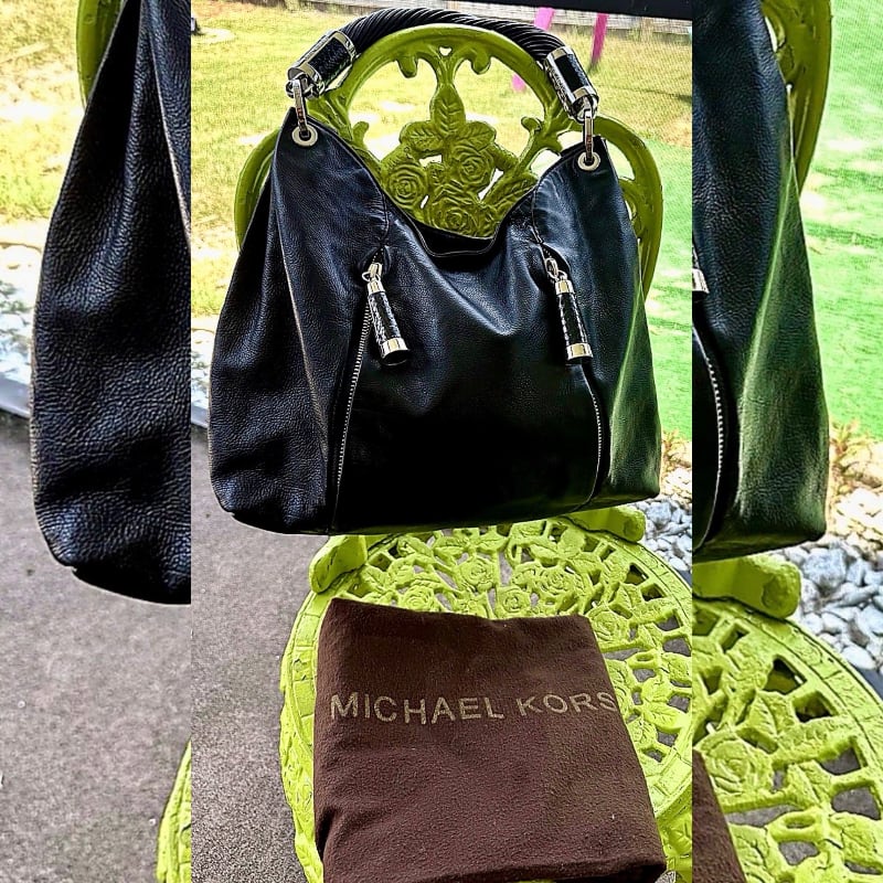 A black leather Michael Kors handbag rests on a bright green ornate chair, with a brown dust bag in front, set against a blurred outdoor background.
