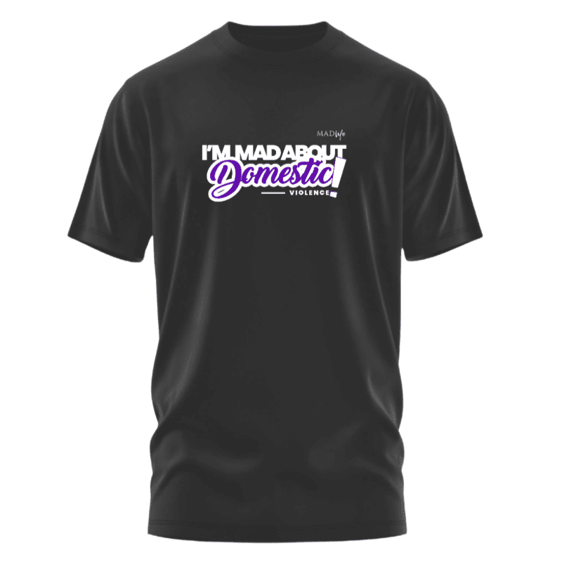 A black t-shirt with the text "I'M MAD ABOUT DOMESTIC VIOLENCE" in white and purple lettering is displayed against a plain white background.