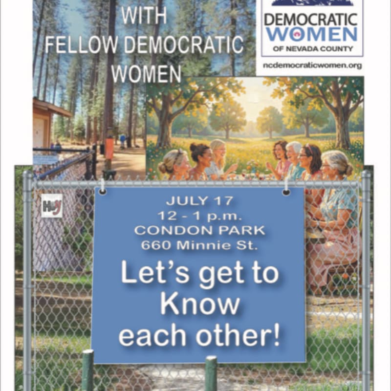 A chain-link fence in the foreground displays a blue sign with event details, while the background shows a group of women gathered outdoors with trees and sunlight.