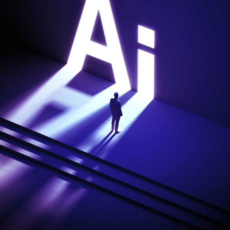 A lone figure stands on steps in the foreground, bathed in the light of the glowing letters "AI" in the background.