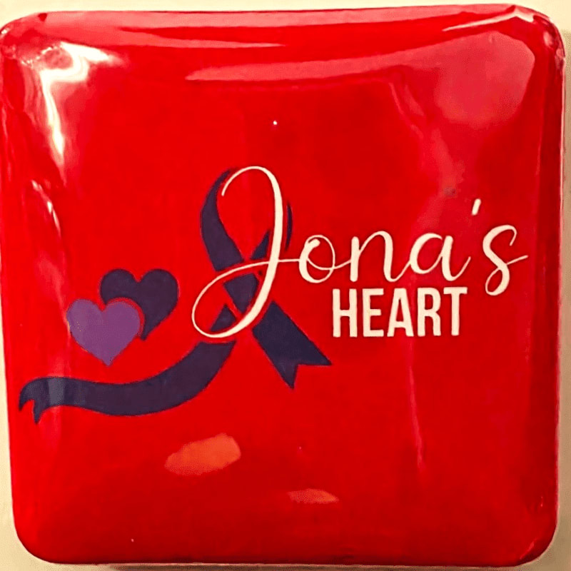 A bright red square object with "Jona's Heart" and two purple hearts is displayed against a plain background.