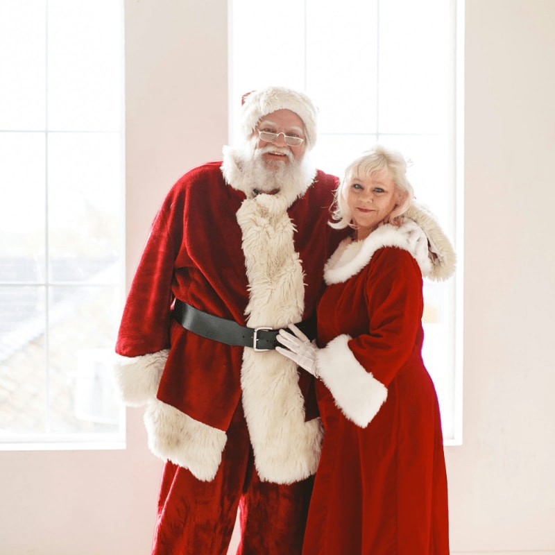 a man and a woman dressed as santa claus