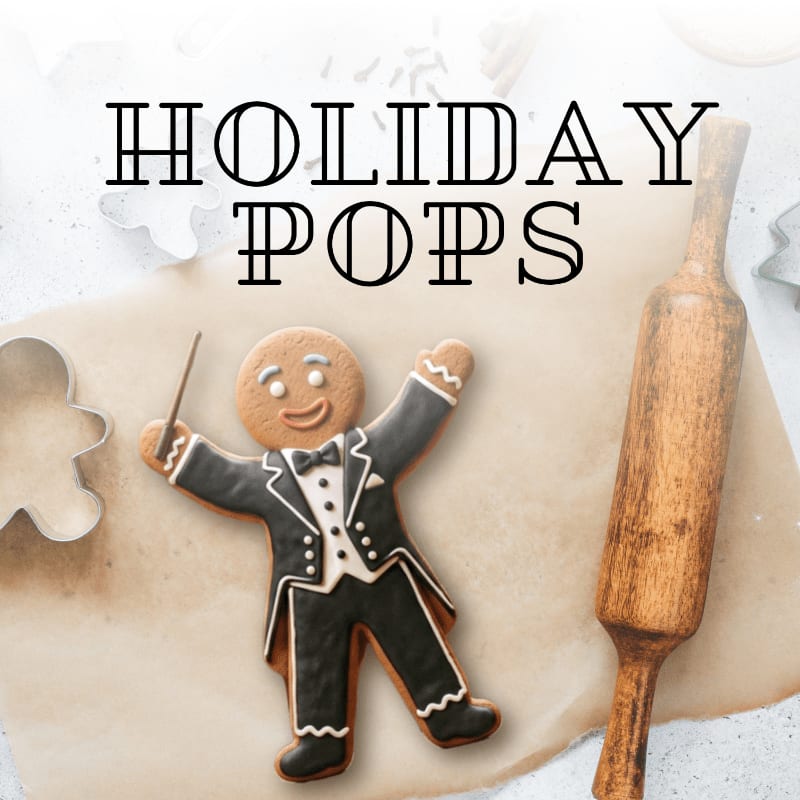 A gingerbread man cookie dressed as a conductor stands on a parchment paper with a rolling pin and cookie cutters in the background, under the words "HOLIDAY POPS".