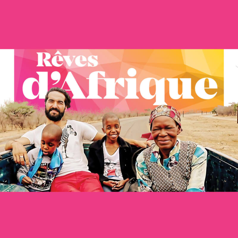 A man and three children are smiling in the back of a truck with a colorful "Rêves d'Afrique" logo above them, set against a dry, savanna-like landscape.