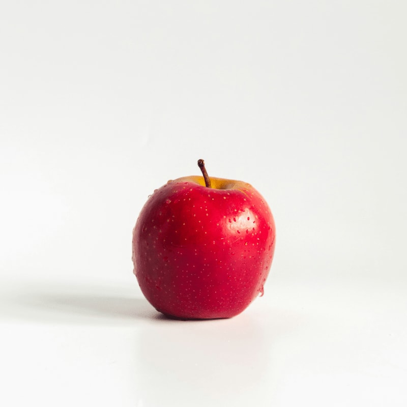 red apple on white surface