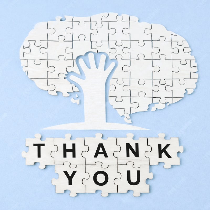 A white tree made of puzzle pieces stands on a light blue background, with the words "THANK YOU" spelled out in puzzle pieces in the foreground.