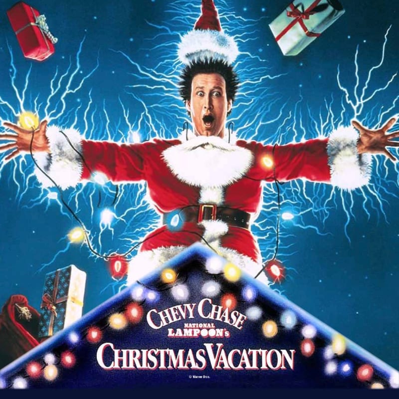 A man in a Santa suit is covered in Christmas lights with presents flying around him against a blue, lightning-filled background.