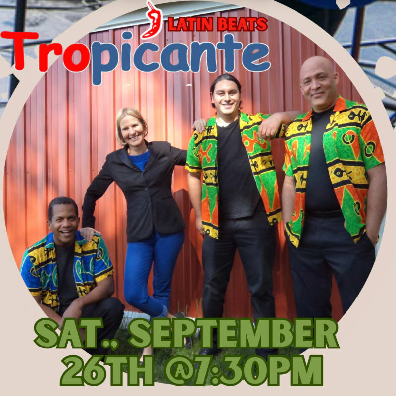 Four people in colorful shirts and a woman in a blue suit pose in front of a red wooden wall, with event details for "Tropicante Latin Beats" on September 26th at 7:30 PM overlaid.