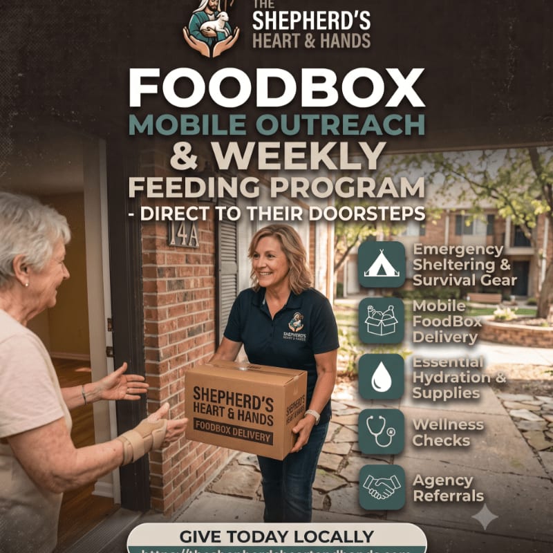 A smiling volunteer hands a food box to an elderly woman at her doorstep, with a brick building and trees in the background.