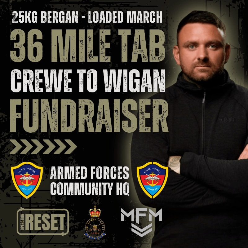 A man in the foreground stands with his arms crossed in front of a background filled with text and logos advertising a 36-mile fundraiser.