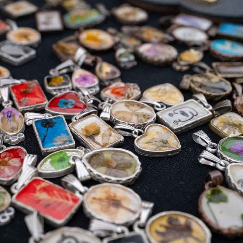 A collection of handmade resin pendants with dried flowers.