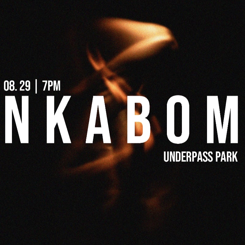 Large white text announcing "NKABOM" with event details "08.29 | 7PM" and "UNDERPASS PARK" is superimposed over a blurry, fiery orange and brown abstract background.