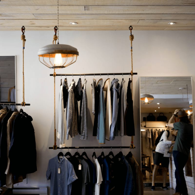 clothing boutique interior with hanging racks