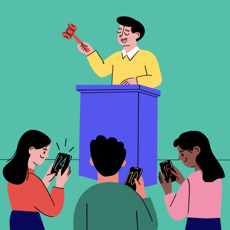 A man in a yellow shirt stands behind a blue podium, holding a gavel, while three people in the foreground look at their phones.