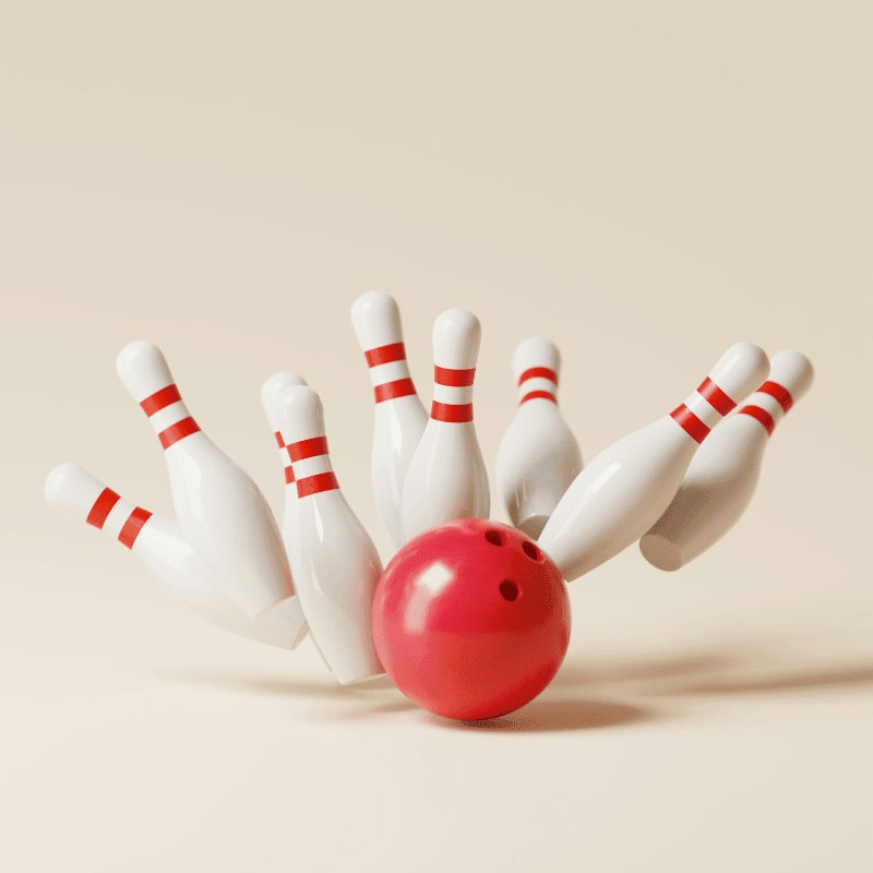 a red bowling ball crashing into the pins