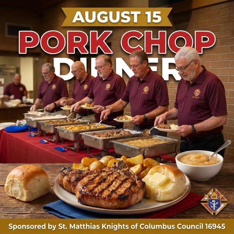A plate of pork chops and sides sits on a wooden table in the foreground, while five men in maroon shirts serve food from a buffet in the background.