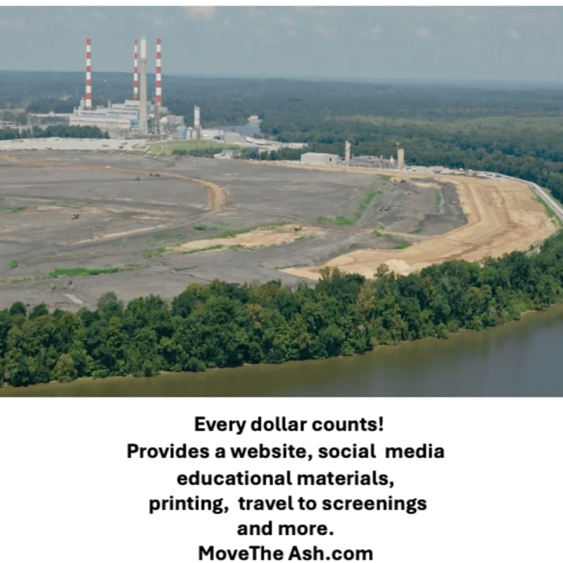 A large industrial complex with smokestacks stands behind a vast expanse of cleared land and a river in the foreground.