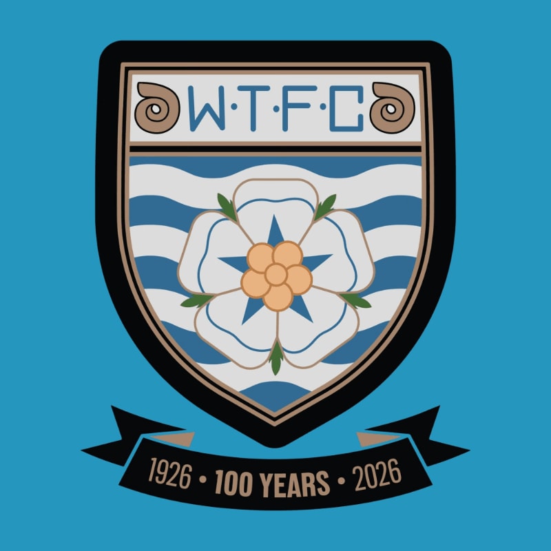 A crest with a white rose and the letters W.T.F.C. is displayed on a blue background with a banner below it.