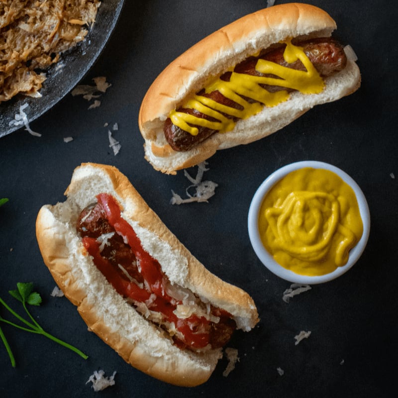 a couple of hot dogs sitting on top of a table