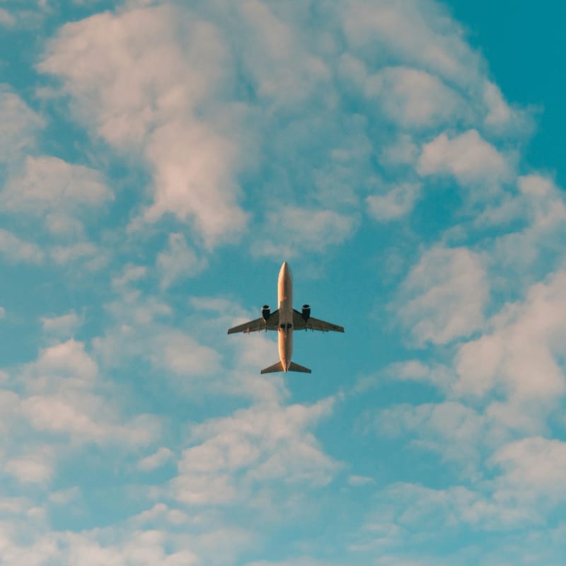 white airplane flying in the sky during daytime