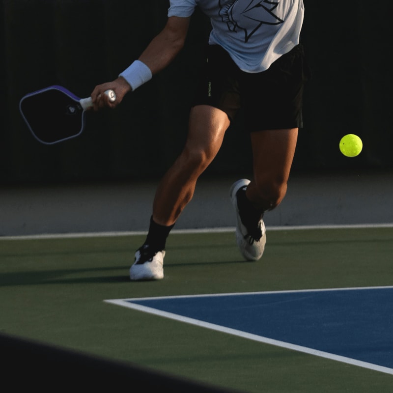 Man playing pickleball on a court